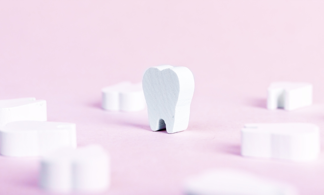 Toy teeth on pink background